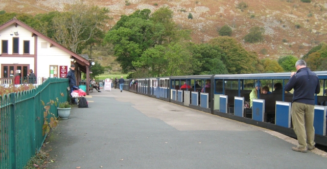 The pretty station at Eskdale with small open carriages in the station